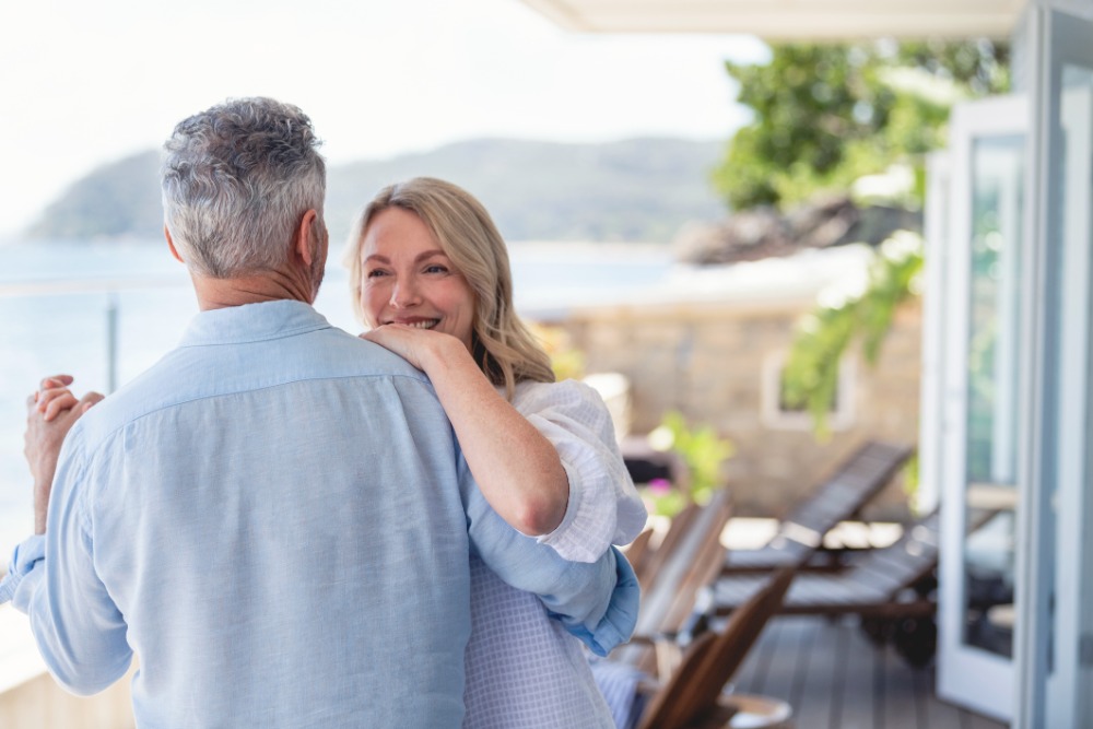 couple dancing at a waterfront home